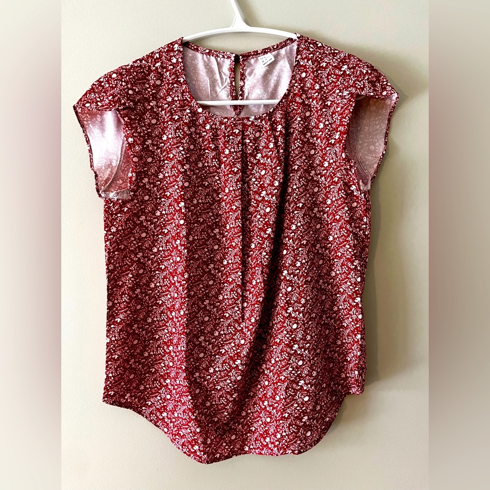 Women’s size medium red printed blouse with button closure in back